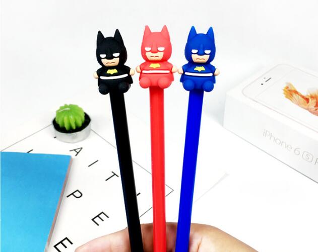 Hand Holding Three Batman Themed Colored Ball Pen